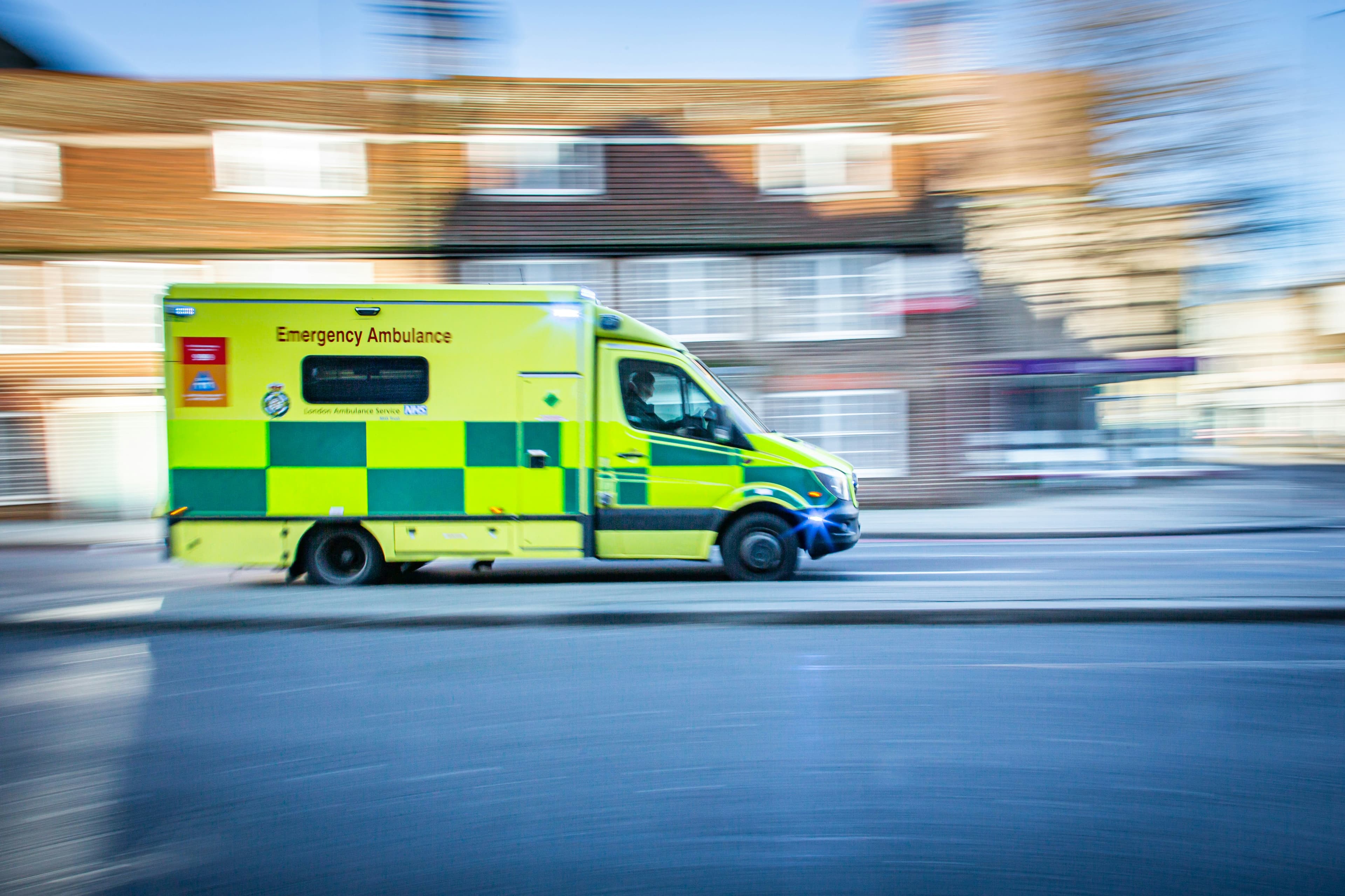 Emergency ambulance racing through street